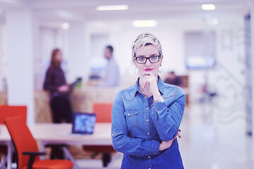 Image showing portrait of young business woman at office with team in backgrou