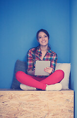 Image showing woman in crative box working on tablet