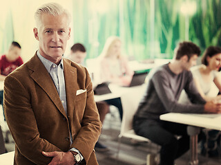 Image showing portrait of in teacher in classroom with students group in backg