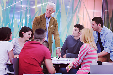 Image showing teacher with a group of students in classroom