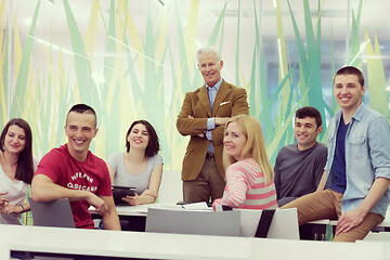 Image showing portrait of  teacher with students group in background