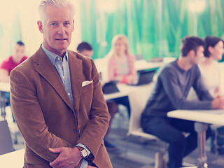 Image showing portrait of in teacher in classroom with students group in backg