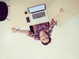 Image showing top view of young business woman working on laptop