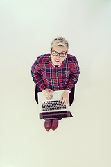 Image showing top view of young business woman working on laptop computer