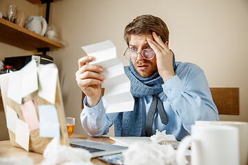 Image showing Sick man while working in office, businessman caught cold, seasonal flu.