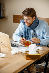 Image showing Sick man while working in office, businessman caught cold, seasonal flu.