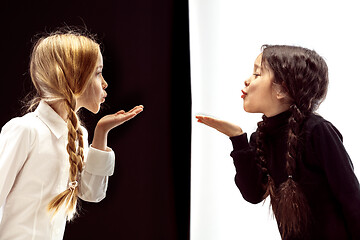 Image showing portrait of two happy girls on a white and black background