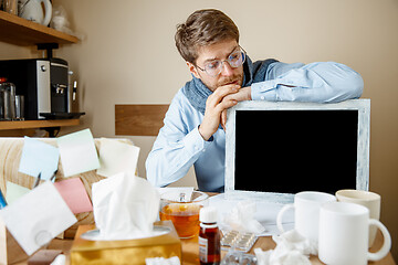 Image showing Sick man while working in office, businessman caught cold, seasonal flu.