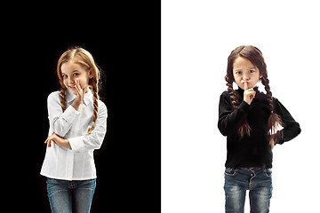 Image showing The young teen girls whispering a secret behind her hand over pink background