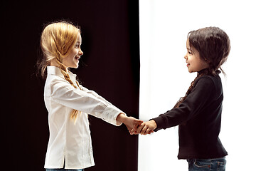 Image showing portrait of two happy girls on a white and black background