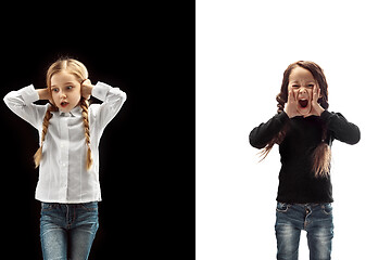 Image showing portrait of two emotional girls on a white and black background