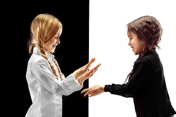 Image showing portrait of two happy girls on a white and black background