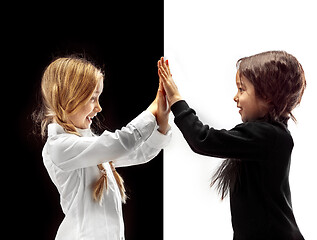 Image showing portrait of two happy girls on a white and black background