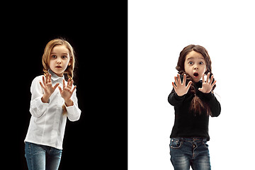 Image showing portrait of two scared girls on a white and black background