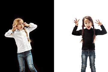 Image showing Angry teen girls standing on studio background.