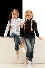 Image showing portrait of two happy girls on a white and black background