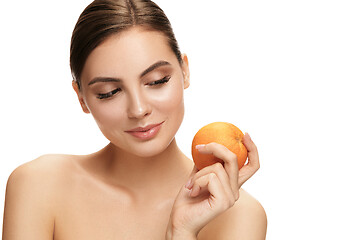 Image showing portrait of attractive caucasian smiling woman isolated on white studio shot eating green apple