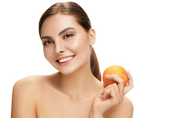 Image showing portrait of attractive caucasian smiling woman isolated on white studio shot eating green apple