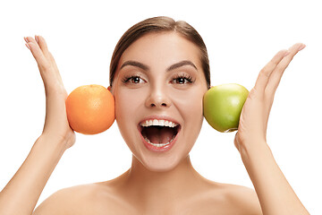 Image showing portrait of attractive caucasian smiling woman isolated on white studio shot eating green apple