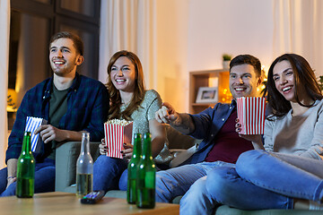 Image showing friends with beer and popcorn watching tv at home