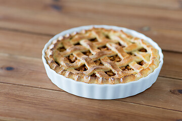 Image showing apple pie in baking mold on wooden table