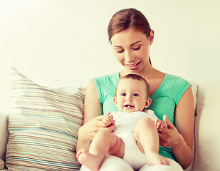 Image showing happy young mother with little baby at home