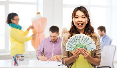 Image showing asian woman with money over fashion design studio