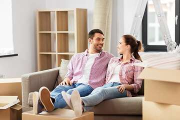 Image showing happy couple with boxes moving to new home