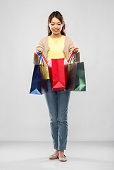 Image showing happy asian woman with shopping bags