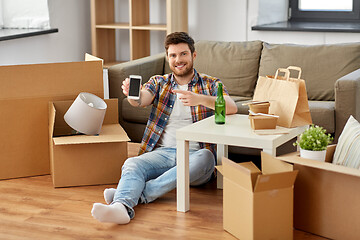 Image showing man with smartphone and takeaway food moving