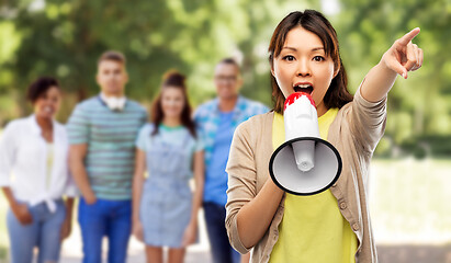 Image showing asian woman speaking to megaphone