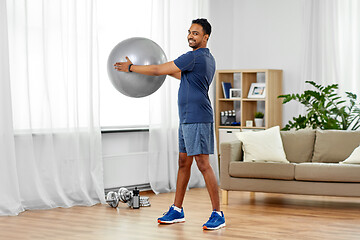 Image showing indian man exercising with fitness ball at home