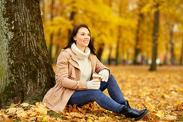 Image showing woman drinking takeaway coffee in autumn park