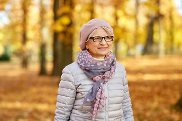 Image showing portrait of happy senior woman at autumn park