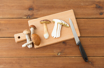 Image showing edible mushrooms, kitchen knife and cutting board