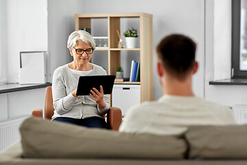 Image showing senior psychologist with tablet pc and patient