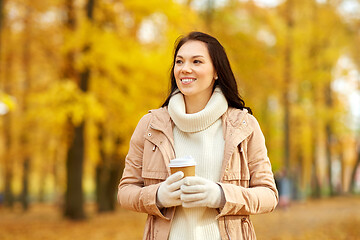 Image showing woman drinking takeaway coffee in autumn park