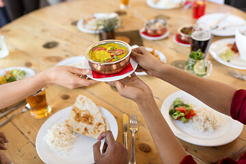 Image showing international friends eating at restaurant