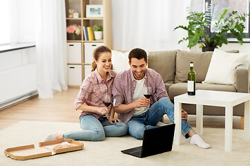 Image showing happy couple with laptop drinking red wine at home