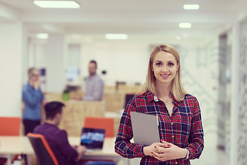 Image showing portrait of young business woman at office with team in backgrou