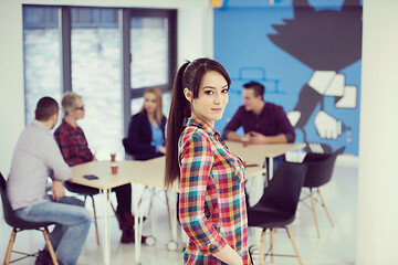 Image showing portrait of young business woman at office with team in backgrou