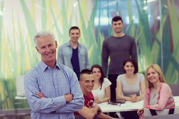 Image showing portrait of  teacher with students group in background