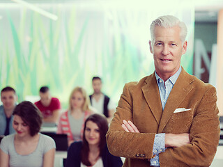 Image showing portrait of in teacher in classroom with students group in backg