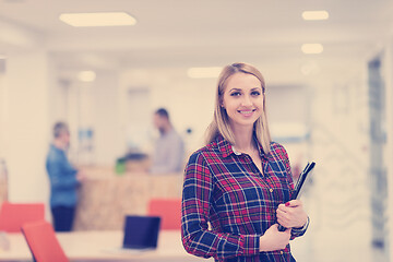 Image showing portrait of young business woman at office with team in backgrou