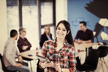 Image showing portrait of young business woman at office with team in backgrou