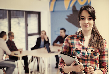 Image showing portrait of young business woman at office with team in backgrou