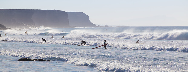 Image showing Surfers surfing on El Cotillo beach, Fuerteventura, Canary Islands, Spain.