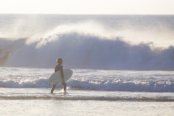 Image showing Surfers on beach with surfboard.