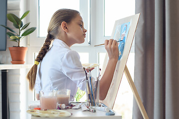 Image showing Young artist draws watercolor in light studio