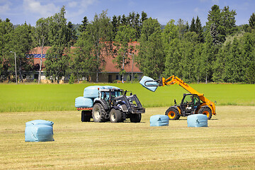 Image showing JCB Telehandler Stacking Bales onto Trailer